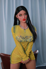 165cm TPE Sex Doll Sienna Full body shot of a woman in a yellow mesh dress standing and leaning against a brown leather chair neutral background