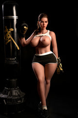 163cm Hybrid Sex Doll Diana Full-body shot of a woman in boxing gear with breasts exposed under a lifted top standing next to a punching bag