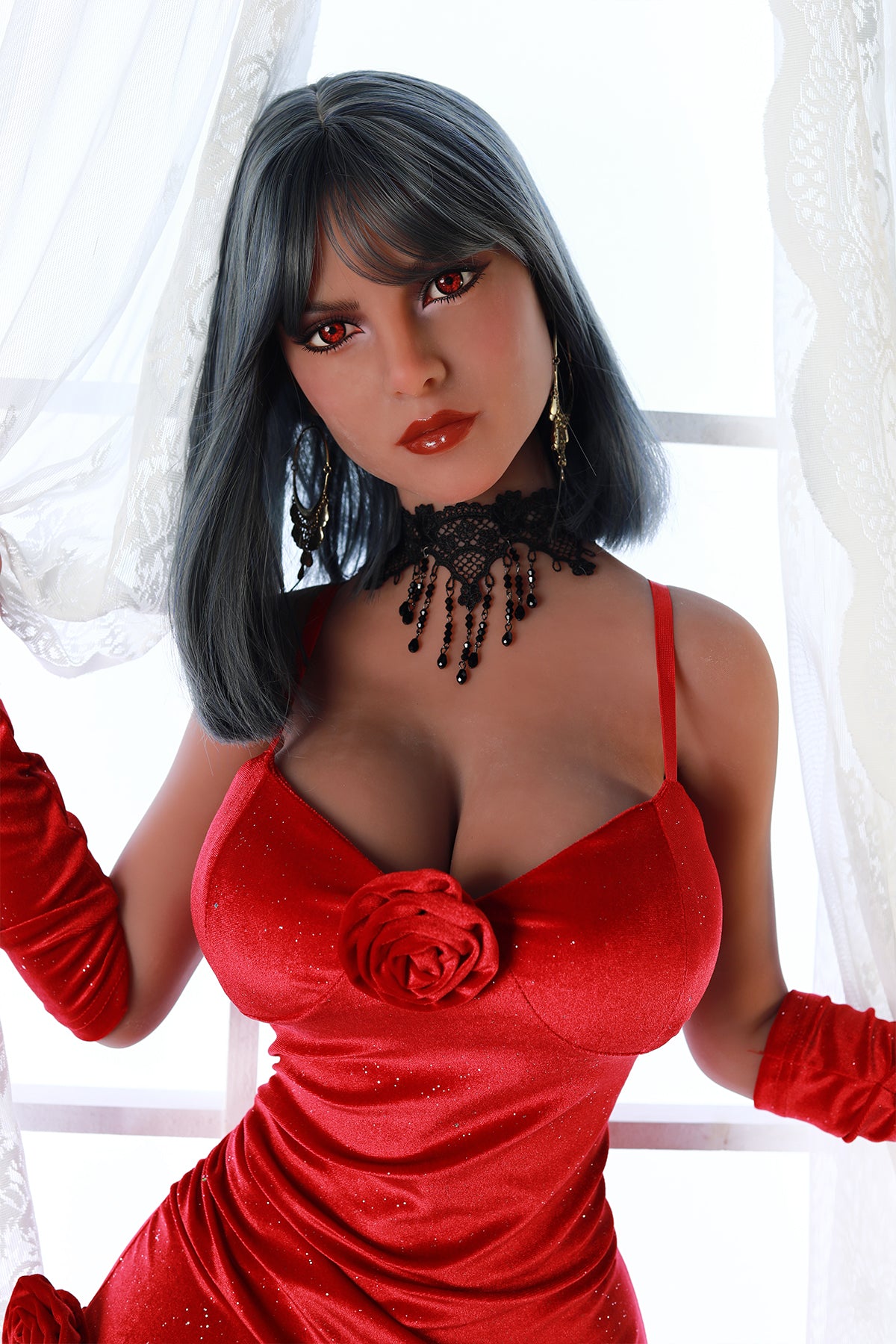 Upper body view of an adult love doll with dark grey hair and red eyes wearing a red velvet dress and black lace choker