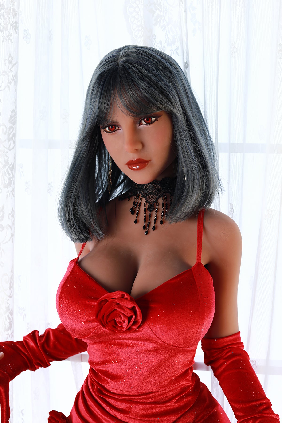 Upper body view of an adult love doll with grey hair and red eyes wearing a red glittery dress and black lace choker