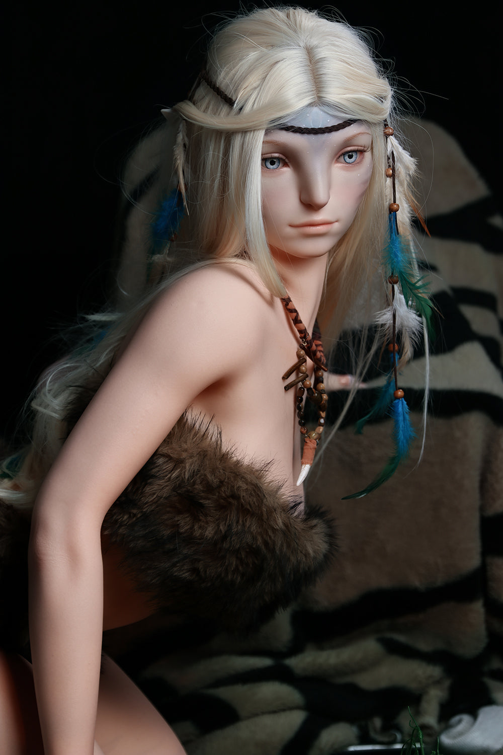 170cm Silicone Sex Doll Madeline Close-up portrait of a blonde elf figure with tribal accessories and blue feathers looking directly at camera